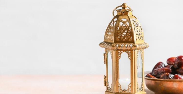 Ramadan 2023: Islamic lamp, dates in bowl displayed on table.