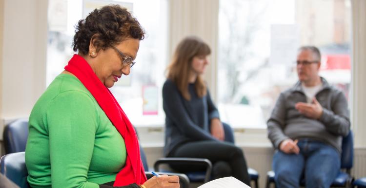 Two people talking in a waiting room