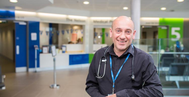 Man standing with stethoscope around his neck