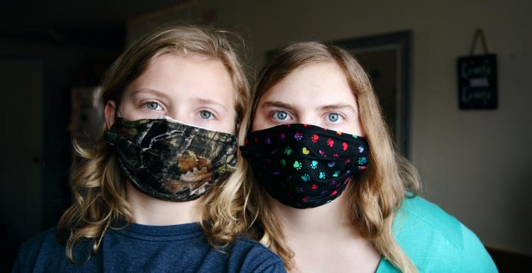 Two young people wearing face masks