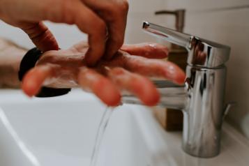 washing hands under tap