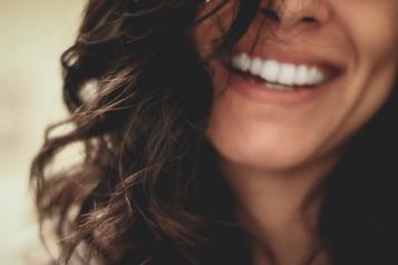 a woman smiling showing her teeth